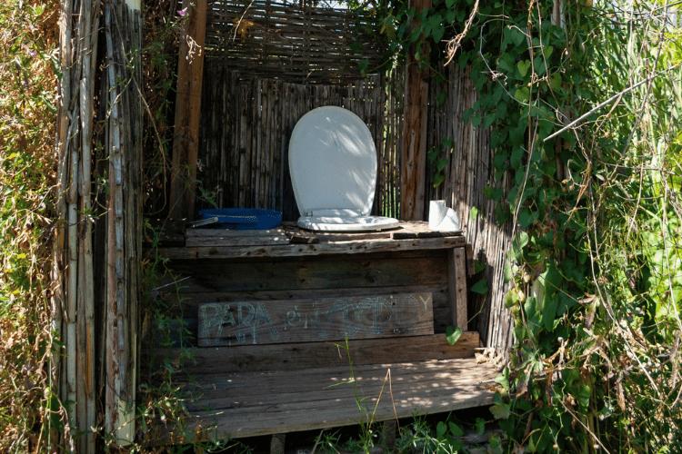 Wooden ecological compost dry toilet surrounded by nature in countryside